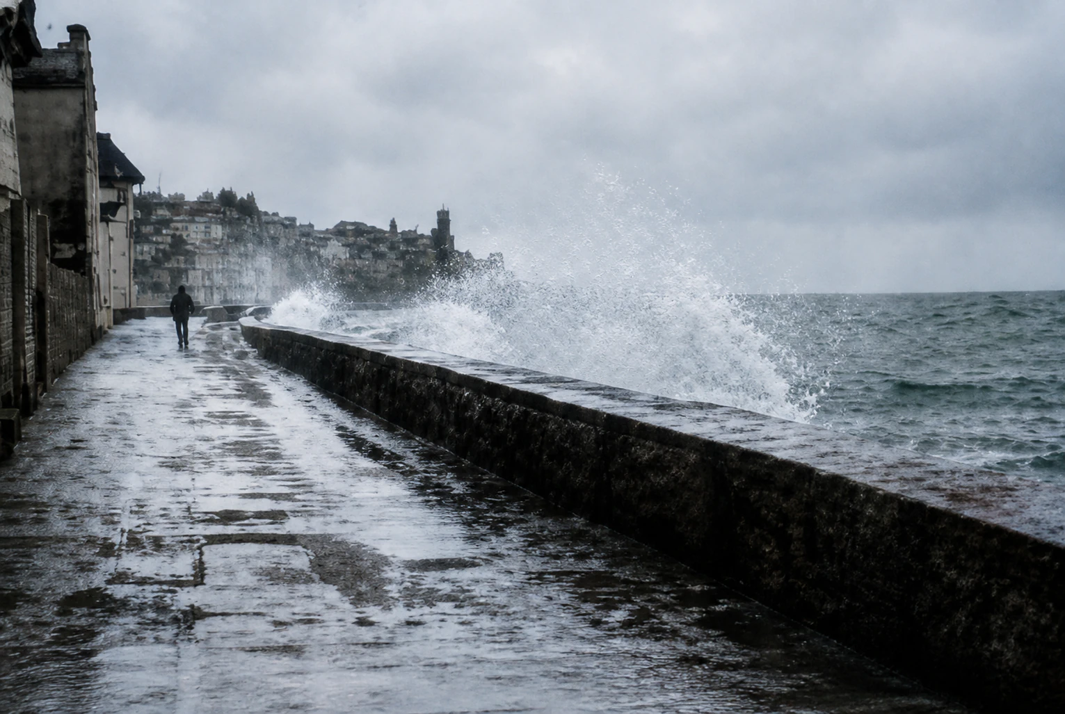 An illustrated photograph of sea spray over a quiet headland